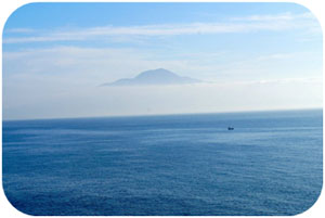 Mount Vesuvius looms over low-lying clouds